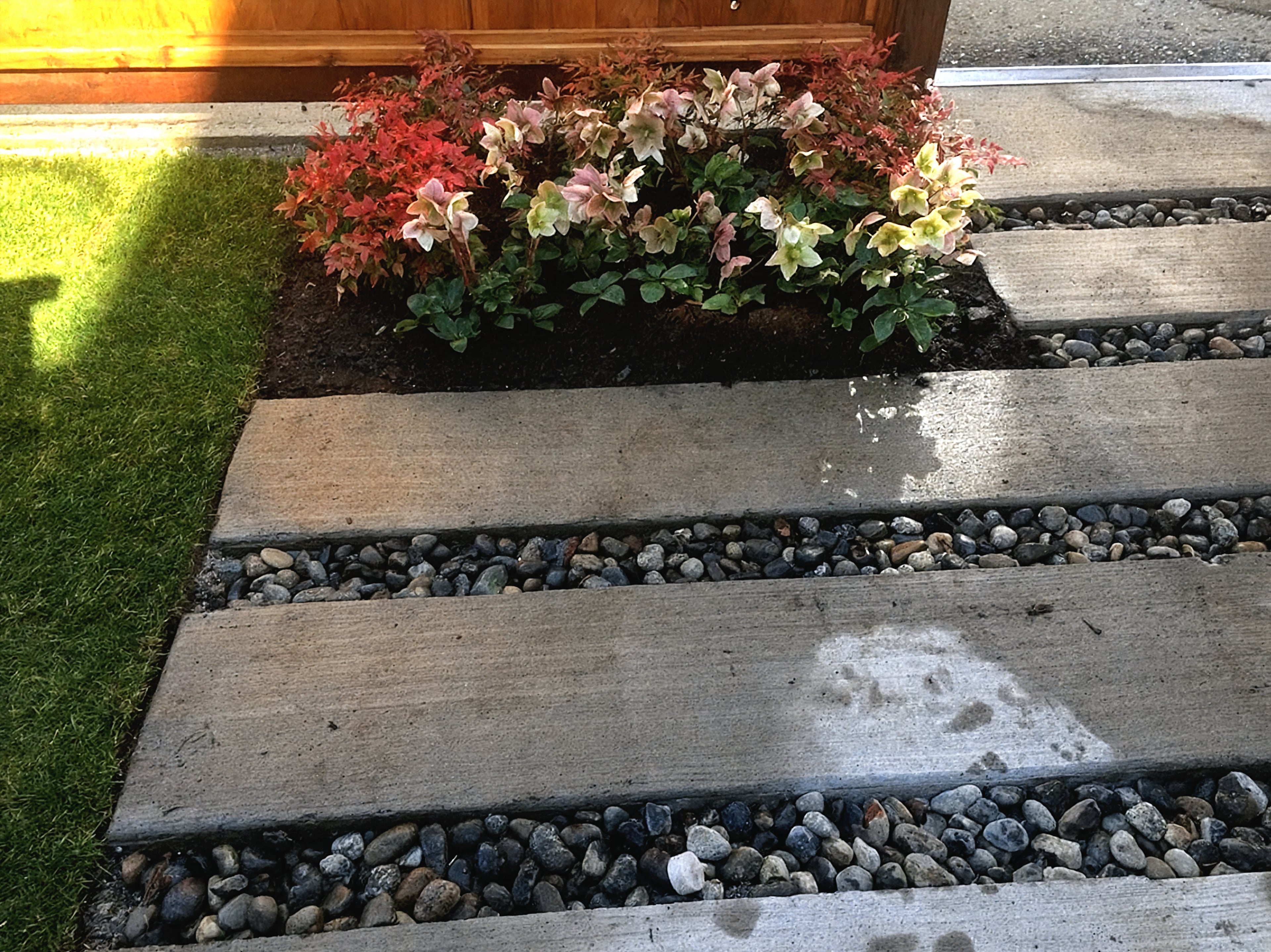 Garden beds, Sod lawn, Concrete slabs and River rock at the East 22nd project.