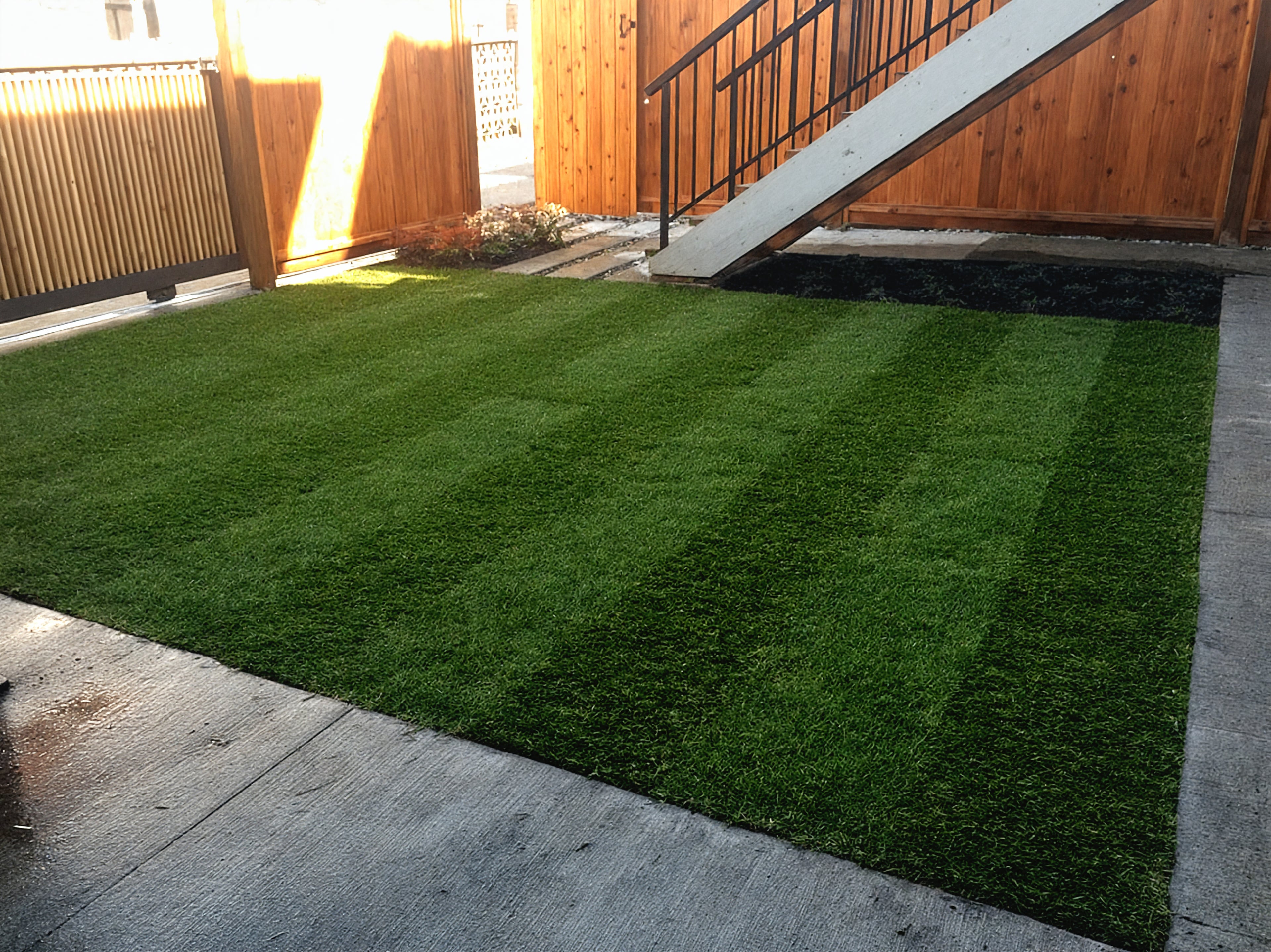 Garden beds, Sod lawn, Concrete slabs and River rock at the East 22nd project.