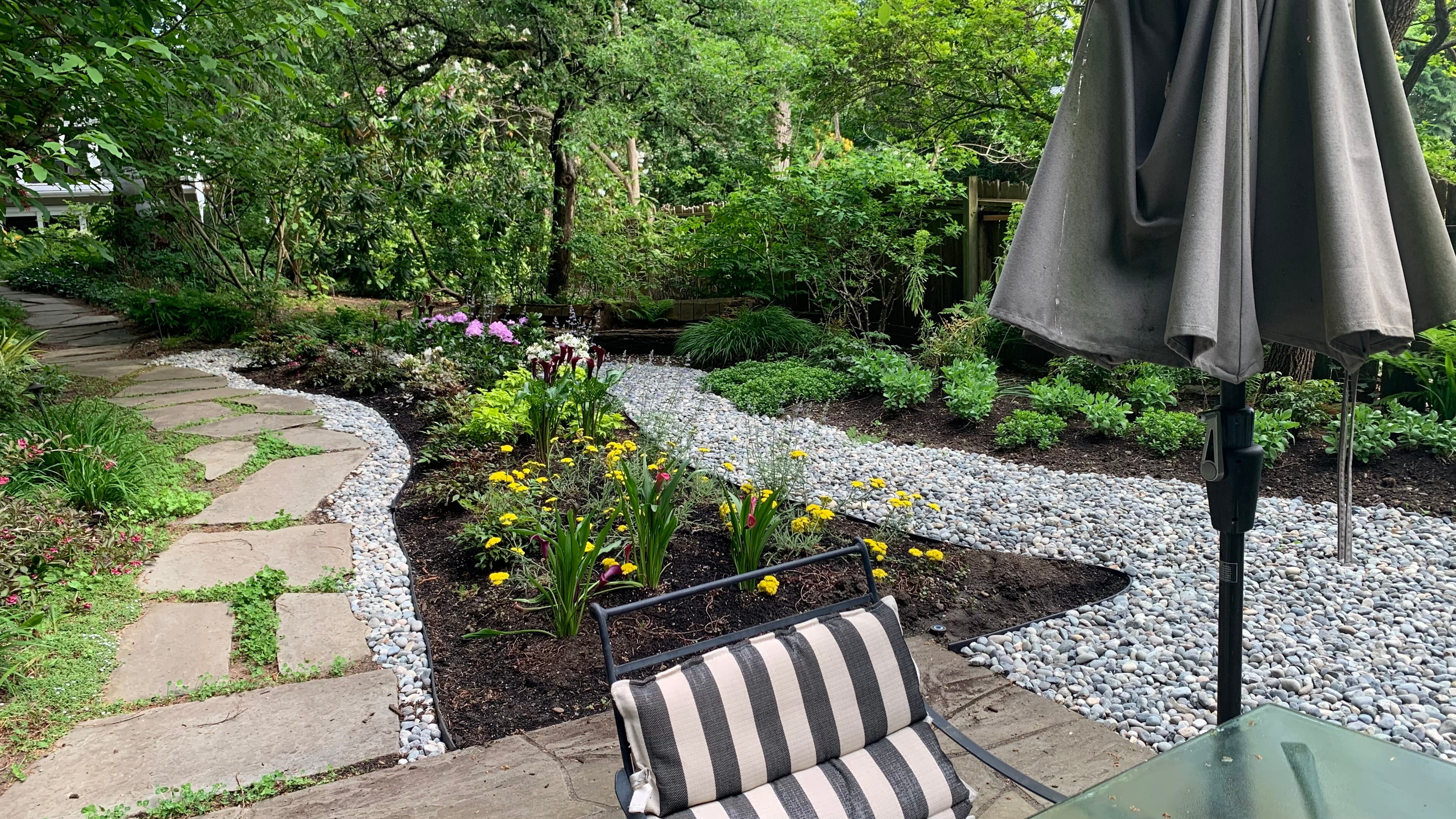 Micro clover, Seasonal planting, Sod lawn and River rock at the Elm St project.