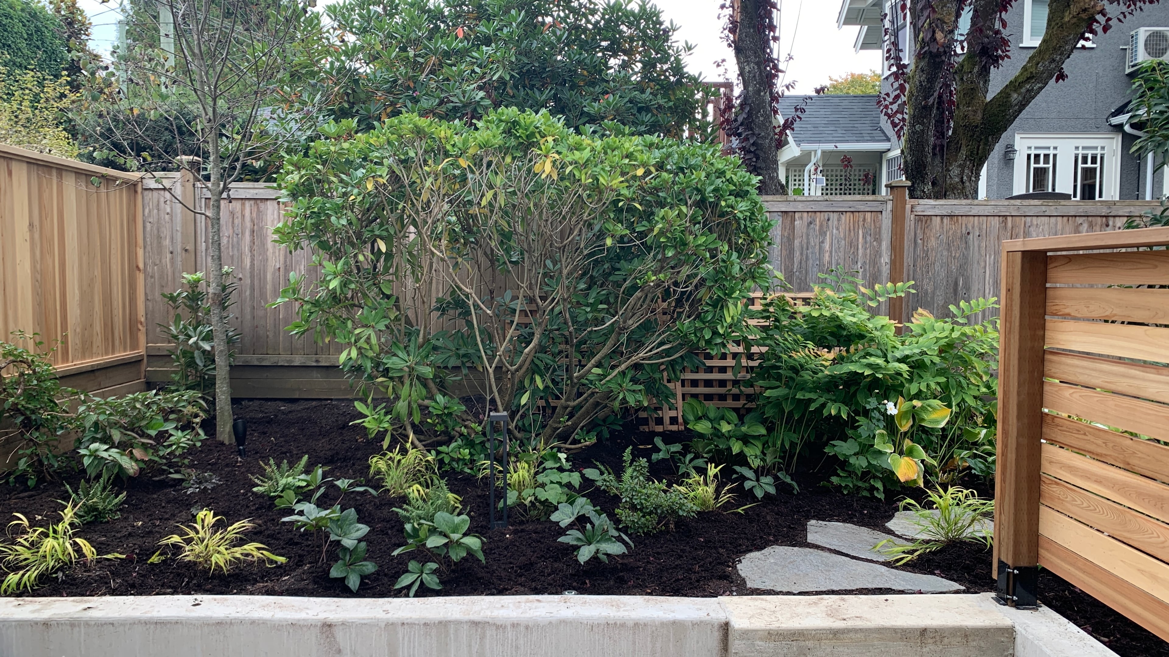 Natural stone pavers, Garden boxes, Hedges and Outdoor Lighting at the West 15th project.