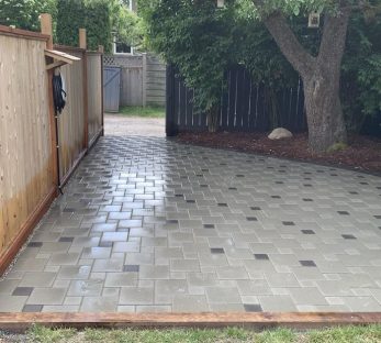 backyard patio installation detail, with tree and fence